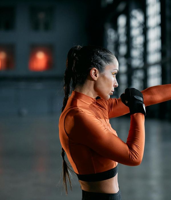 Woman in comfortable sportswear feeling energetic and light during a cardio exercise indoors.